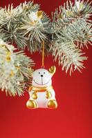 Bull figure on a Christmas tree on a red background, free space for text. photo