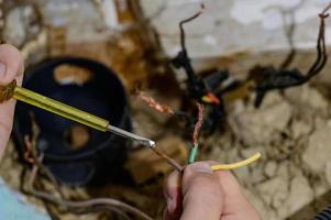 Old electrical wiring in the house, wooden walls in the house, replacement of electrical cables. photo