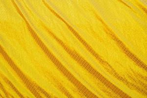 Yellow bed linen gradient texture blurred curve style of abstract luxury fabric,Wrinkled bed linen and gold shadows,background photo