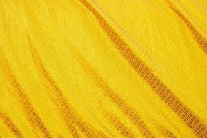 textura de gradiente de ropa de cama amarilla estilo de curva borrosa de tela de lujo abstracta, ropa de cama arrugada y sombras doradas, fondo foto