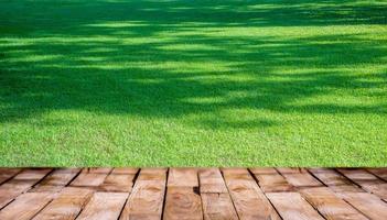 Beautiful  wooden floor and green lawn nature background, agriculture product standing showcase background photo
