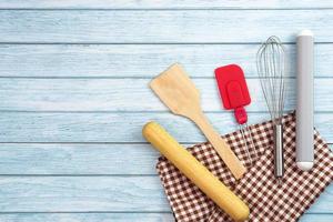 Top view set of kitchen utensils and ingredients for bakery on blue wooden floor. photo