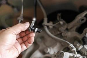 Close up ABS brake sensor of car wheel check for abnormalities to ensure the safety of the brakes service concept photo
