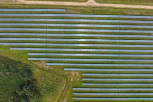 aerial view on farm field of solar panels. Renewable solar energy. photo