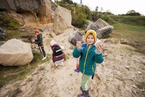 Boy explore limestone stones at mountain in Pidkamin, Ukraine. photo