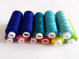 colored threads for sewing on a white background photo