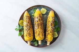 barbecue and grilled corn with cheese and lime photo