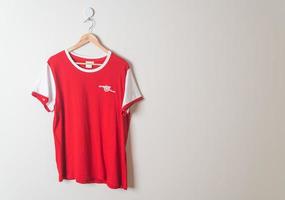 Bangkok, Thailand - Jan 18, 2022 - Arsenal retro shirt hanging on wall photo