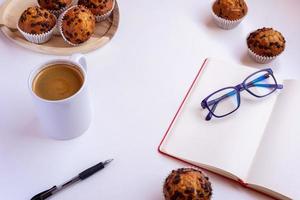 Early morning concept. Day starts with muffins, planner and coffe. photo