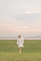 Happy young Asian women in bride clothing with veil photo