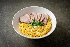 dried duck noodles in white bowl photo