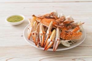 Steamed blue crab with spicy seafood sauce photo