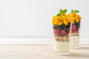 homemade mango, raspberry and blueberry with yogurt and granola photo