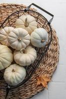 White pumpkins and autumn leaves photo