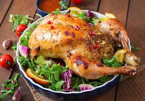 Baked chicken stuffed with rice for Christmas dinner on a festive table photo