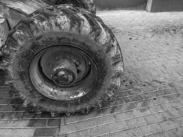 Powerful big wheels with tread and tires of off-road construction equipment, tractors, cars photo