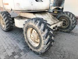 Powerful big wheels with tread and tires of off-road construction equipment, tractors, cars photo