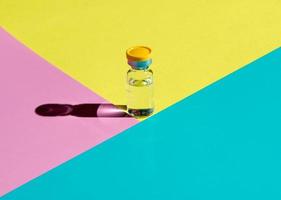 A bubble with a transparent liquid on a colored background. The concept of a medicinal product. photo