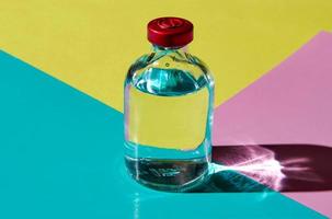 A bubble with a transparent liquid on a colored background. The concept of a medicinal product. photo