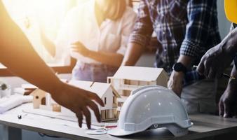 Construction engineer working at blueprint to build large commercial buildings in office. Engineering tools and construction concept. photo