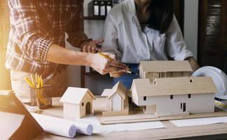 Construction engineer working at blueprint to build large commercial buildings in office. Engineering tools and construction concept. photo