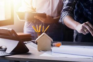 Construction engineer working at blueprint to build large commercial buildings in office. Engineering tools and construction concept. photo