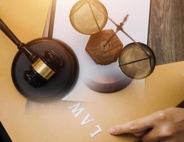 Business and lawyers discussing contract papers with brass scale on desk in office. Law, legal services, advice, justice and law concept picture with film grain effect photo