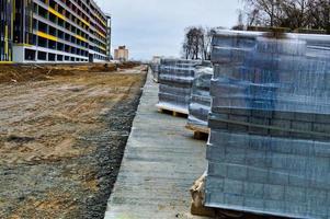 Industrial construction and repair of roads and sidewalks with laying of asphalt and paving slabs using modern building materials and technologies photo