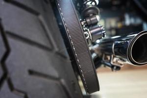 Motorcycle rear belt drive at garage, belt drive reduces maintenance and quieter than chains. maintenance,repair motorcycle concept,selective focus photo