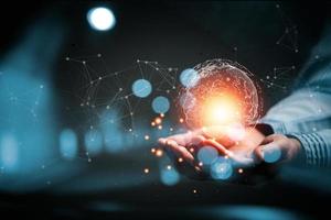 woman Hand holding Light bulb Global Internet connection. Business global internet connection application technology and digital marketing, Financial and banking, Digital link tech, big data. photo