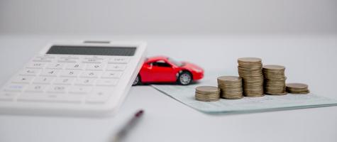 Concept of car insurance business, saving buy - sale with tax and loan for new car. Car toy vehicle with stack coin money on background. Planning to manage transportation finance costs. loan for car photo