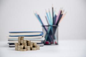 Concept to saving money income for study, Calculating student finance costs and investment budget loan. close-up education object with stack money coin-cash dollar and glass jar on background. photo