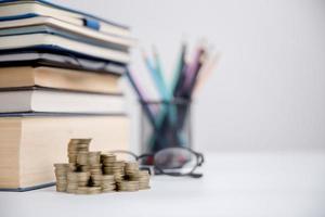 Concept to saving money income for study, Calculating student finance costs and investment budget loan. close-up education object with stack money coin-cash dollar and glass jar on background. photo