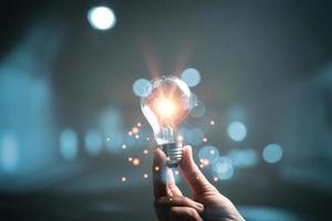 woman Hand holding Light bulb Global Internet connection. Business global internet connection application technology and digital marketing, Financial and banking, Digital link tech, big data. photo