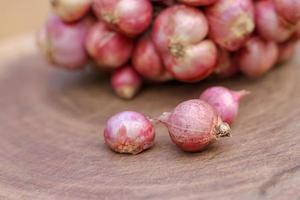 Shallots still on wood background photo