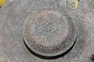 old and rusty gas stove burner head photo