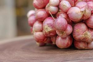 Shallots still on wood background photo