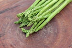 Raw asparagus. Fresh Asparagus on wooden background photo