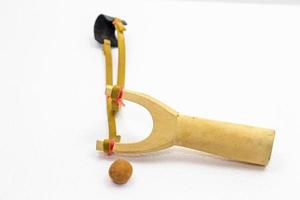 Handmade slingshot catapult. Y-shaped wooden stick with elastic tied between two top parts. Slingshot or Catapult is device for shooting small stones. photo