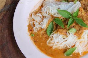 Fresh noodles with spicy Thai curry is a local food in Southern of Thailand. photo