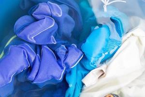 Soak colored clothes before washing them with water. photo