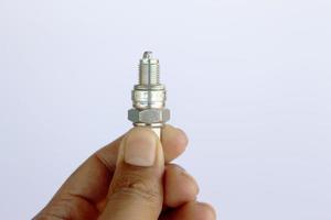 New spark plug in hand before use. photo