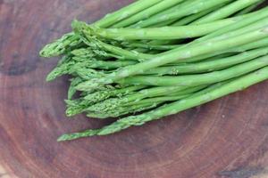 Raw asparagus. Fresh Asparagus on wooden background photo