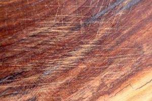 Brown scratched wooden cutting board. Wood texture photo