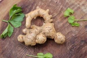 Ginger root  on wooden background photo