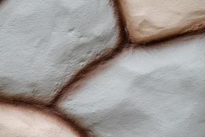 Stone wall texture in brown color and pink color use for background. photo