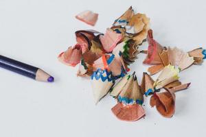 Colored pencil and sawdust caused by a pencil sharpener on the White Blackground photo