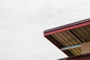 The gable roof with the sky with clouds background. photo