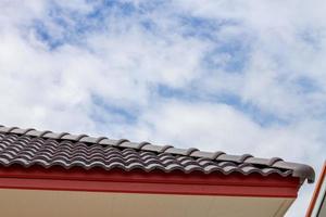 The gable roof with the sky with clouds background. photo