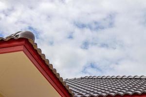 The gable roof with the sky with clouds background. photo